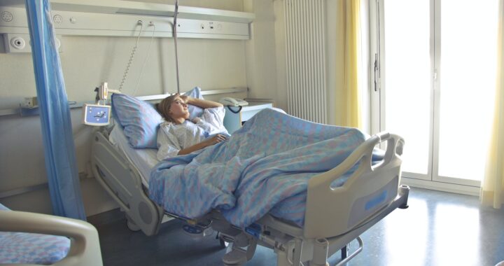photo of woman lying in hospital bed
