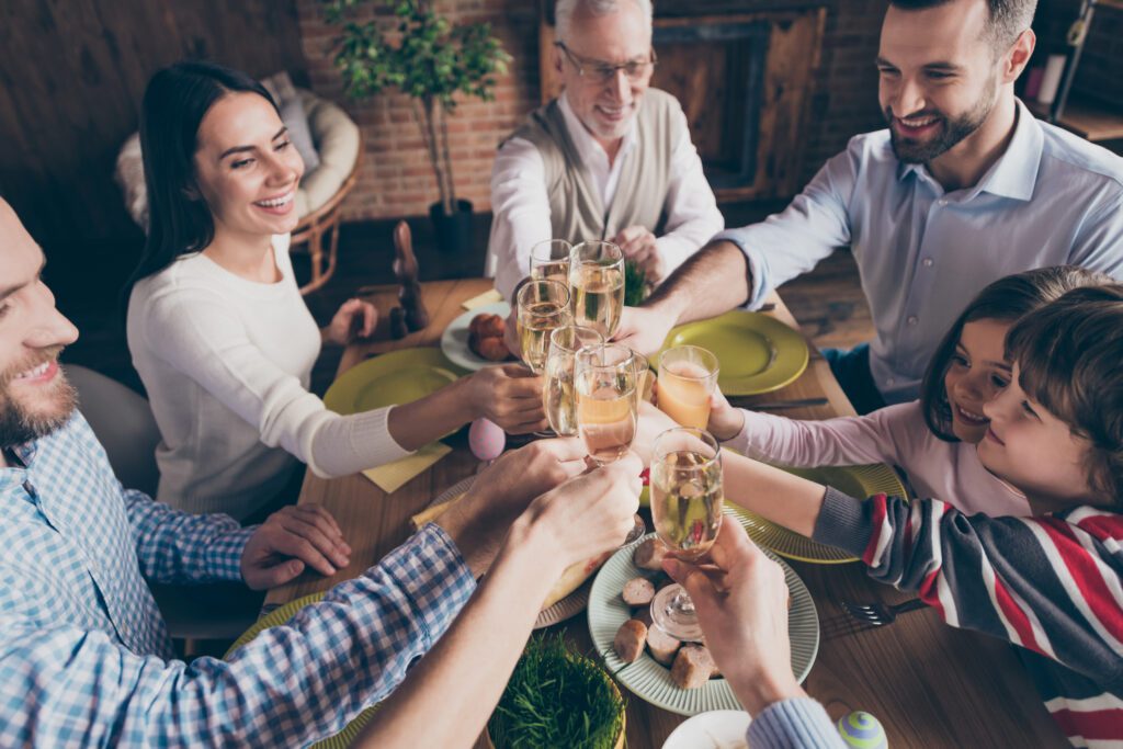 "Easter dinner with a beautifully decorated table, featuring a delightful spread of lamb, chicken, ham, and other mouthwatering dishes."