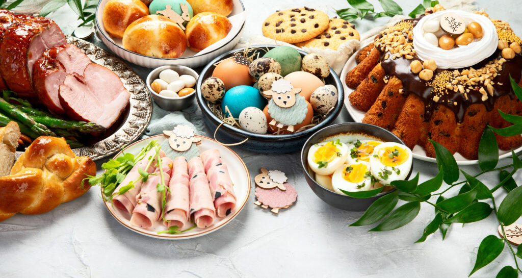 "Easter dinner with a beautifully decorated table, featuring a delightful spread of lamb, chicken, ham, and other mouthwatering dishes."