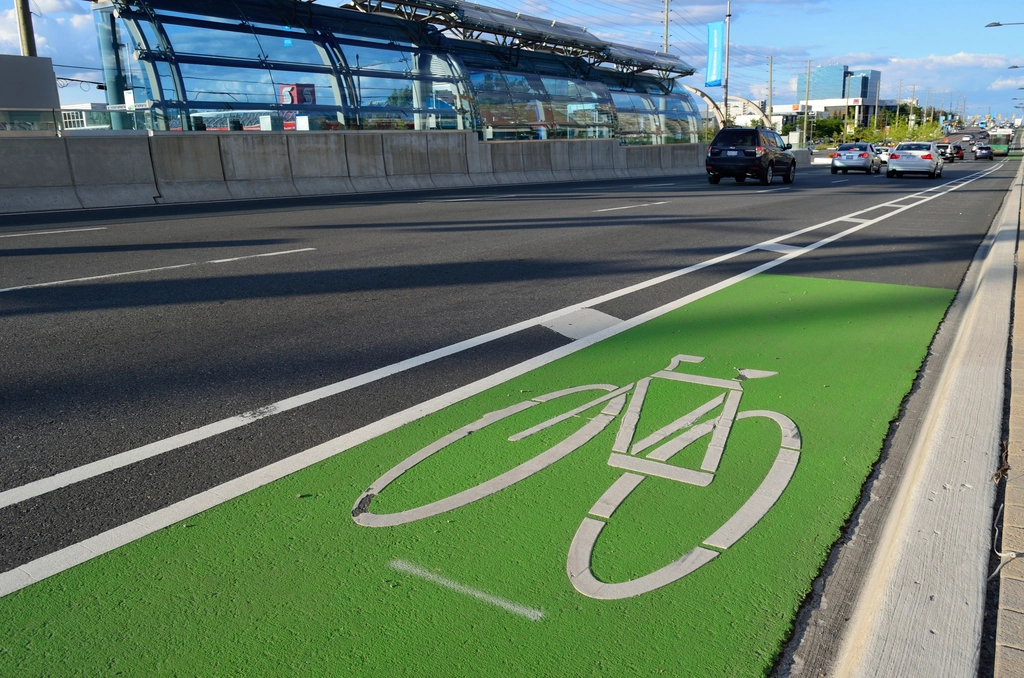 Bike lane in a bustling city, with cyclists commuting and enjoying a safe and dedicated cycling space.