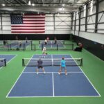 "Pickleball players enjoying a match on TPS Court Surfacing at Topseed Pickleball in Tulsa."