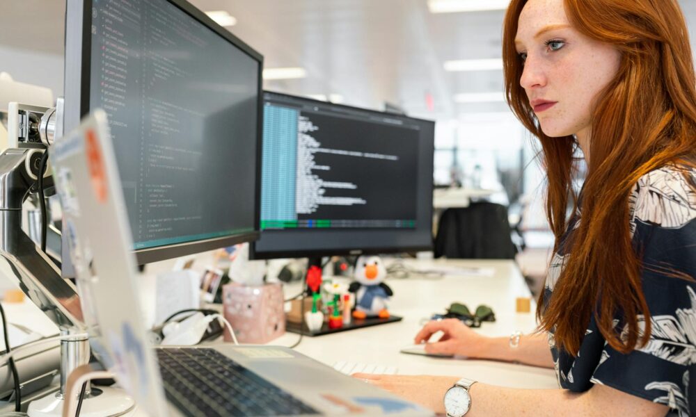 woman coding on a computer. CrowdStrike