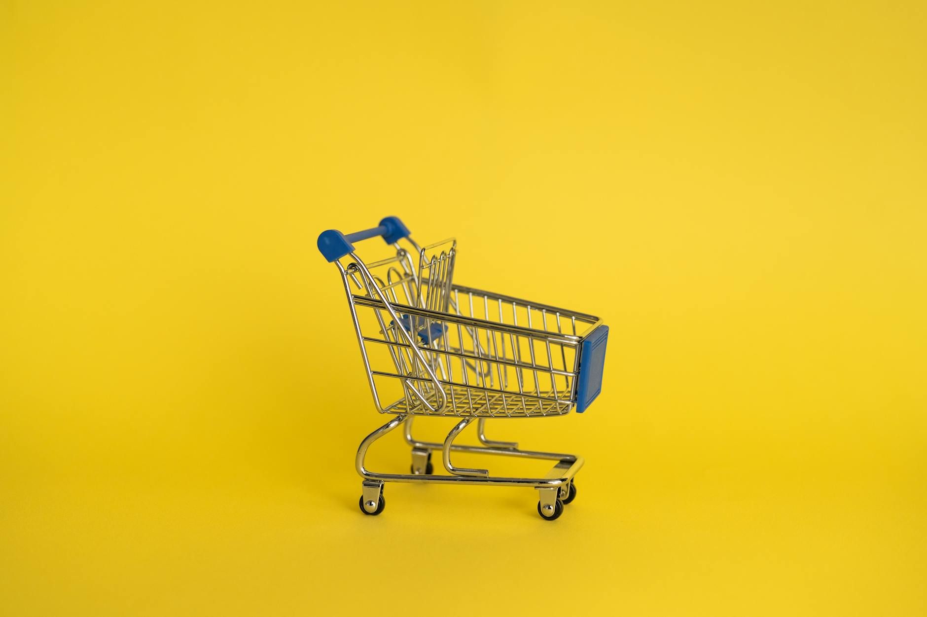 empty shopping cart on yellow background.Kroger
