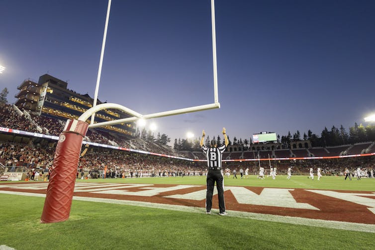 A referee makes a ruling on a football field.