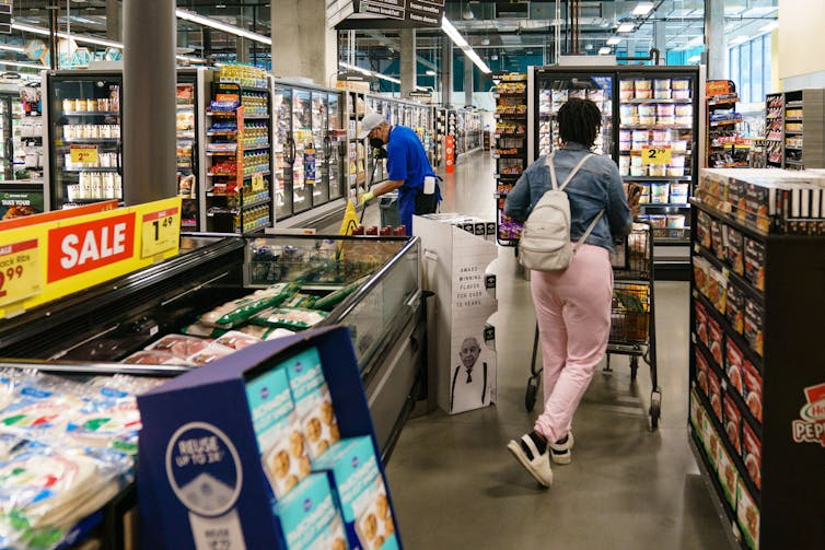 Shoppers are seen in a supermarket.