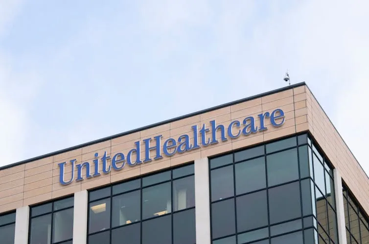 Image of corporate office building with glass windows and a sign reading 'UnitedHealthcare.'