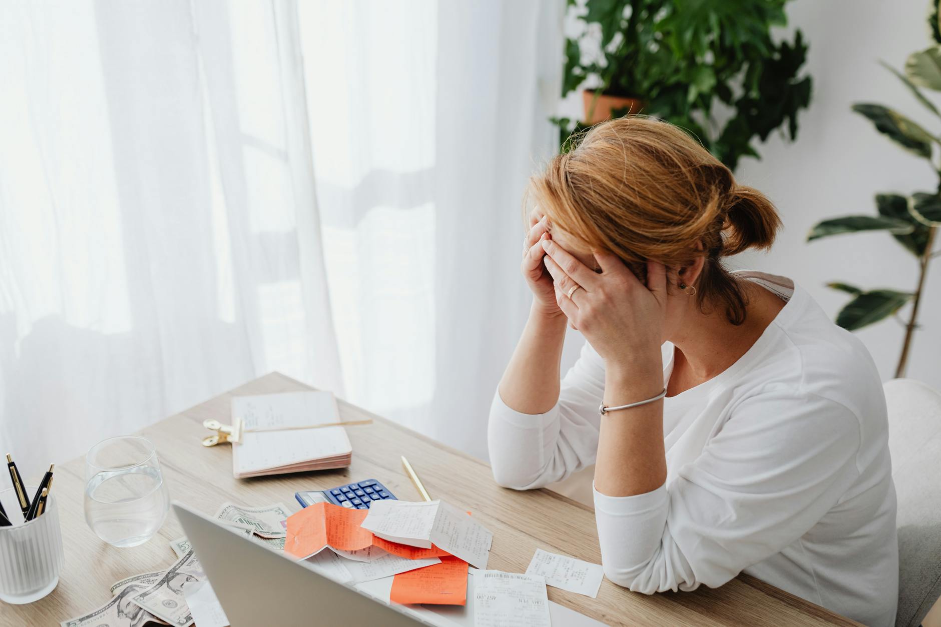 woman and receipts on desk. Debt collector