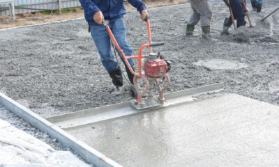 construction workers smoothing fresh concrete outdoors