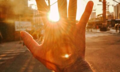 a hand covering sun glare