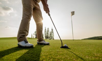 man prepares golf putt on green field 2026 03 16 22 56 01 utc